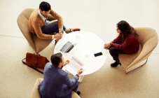  Three people having a discussion in coffee table