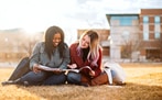 Students reading on a lawn